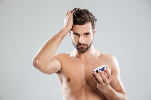 Free photo young man holding cream isolated