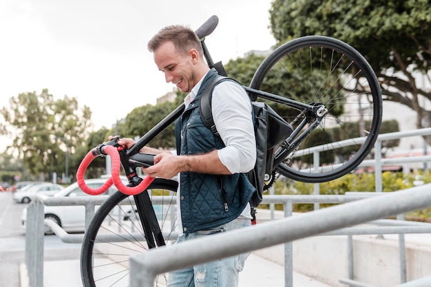 Young man holding his bike