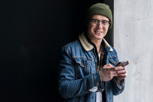 Young man holding his phone