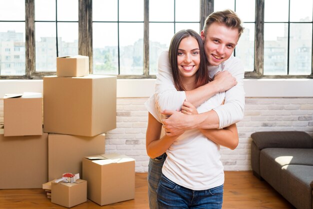 Young man holding his smiley girlfriend