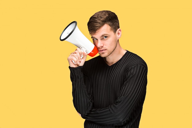 Free photo the young man holding a megaphone