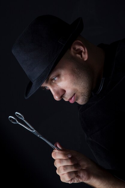 Young man holding scissors