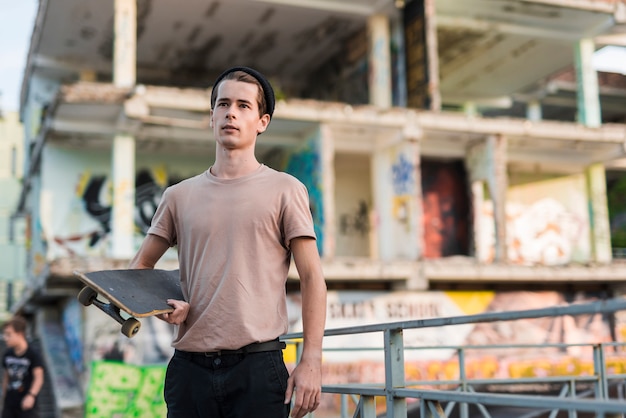 Young man holding a skateboard