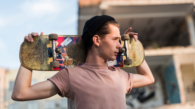 Young man holding a skateboard