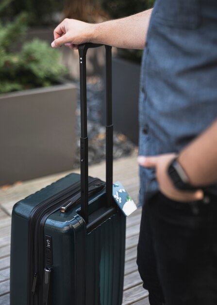 Young man holding a suitcase