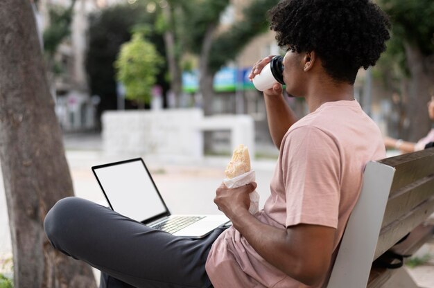 Young man holding a takeaway coffee