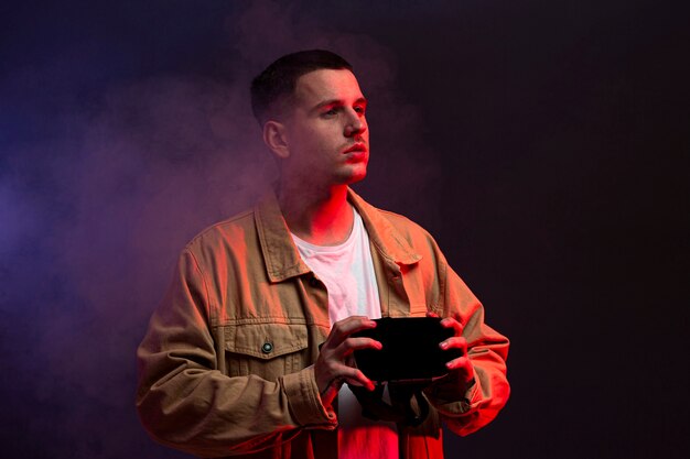 Young man holding virtual reality goggles