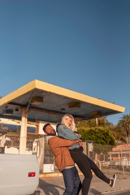 Young man hugging his girlfriend and elevating her