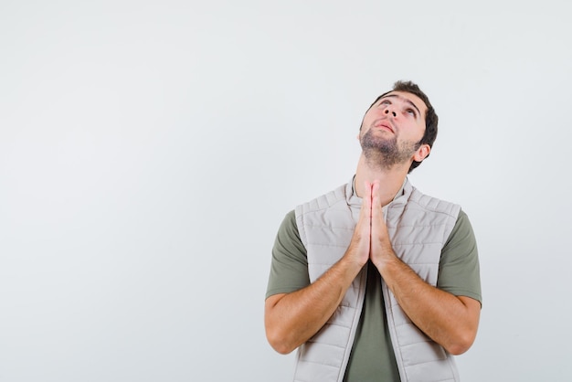 The young man is begging on white background