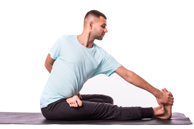 Young man is making yoga isolated over white background