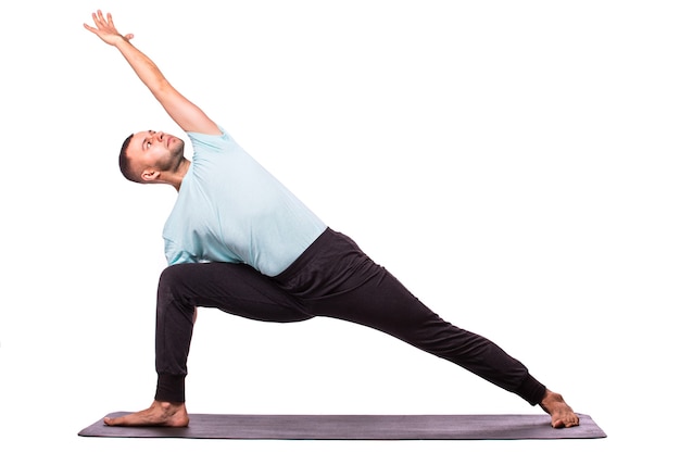 Young man is making yoga isolated over white background