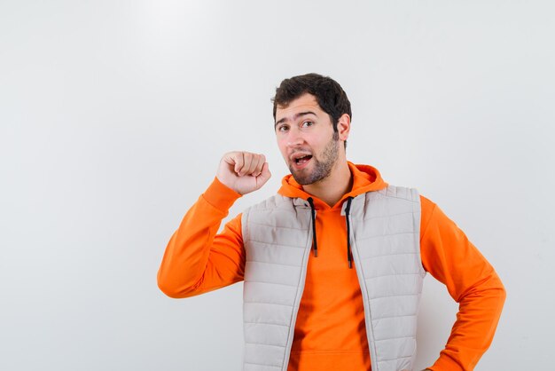 The young man is showing his fist  on white background