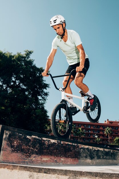 Young man jumping with bicycle 