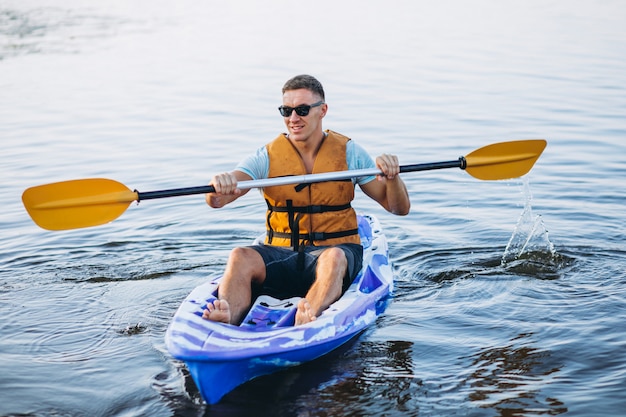 Young Man Kayaking On The River