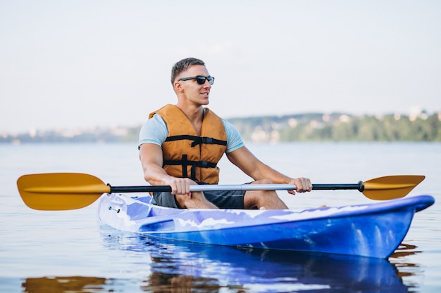 Young man kayaking on the river