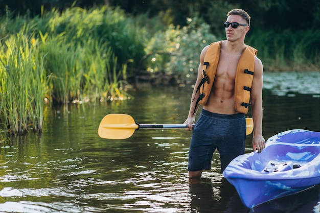 Free photo young man kayaking on the river