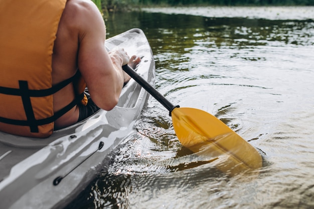 Young man kayaking on the river