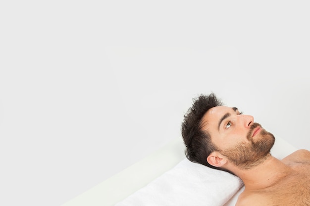 Young man laying down with copy space