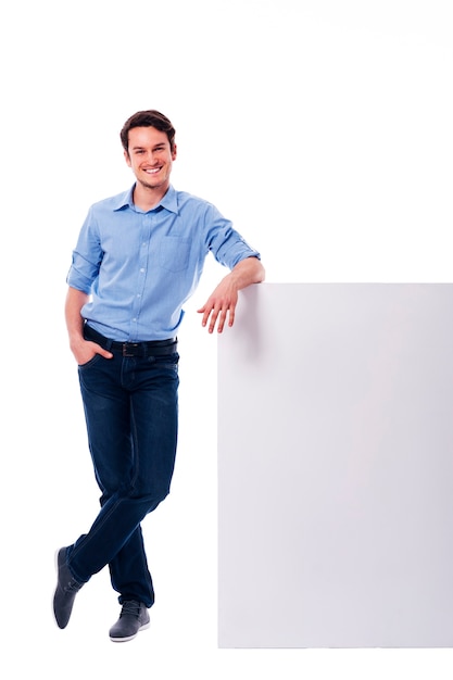 Young man leaning on the empty board