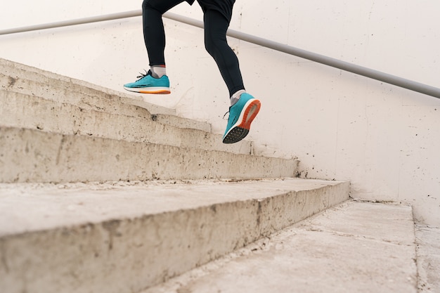 Young man legs doing interval workout on stairs