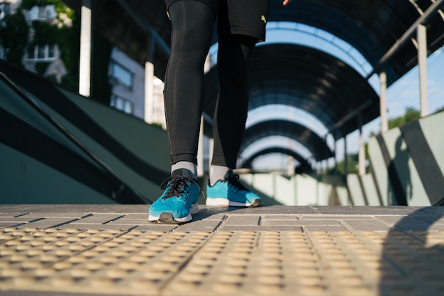 Free photo young man legs practicing interval workout on stairs