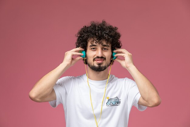 young man listening to music on red,