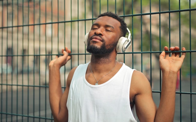 young man listens to the music with bluetooth headphones