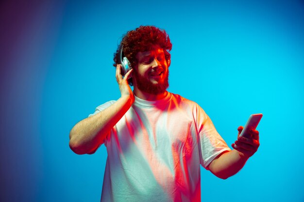 Young man listens to music with headphones