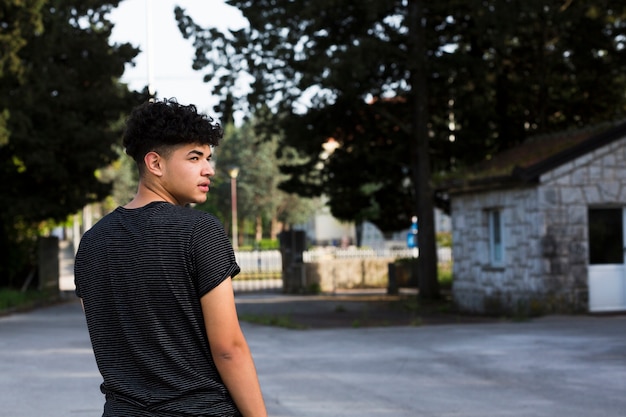 Free photo young man looking back in urban environment