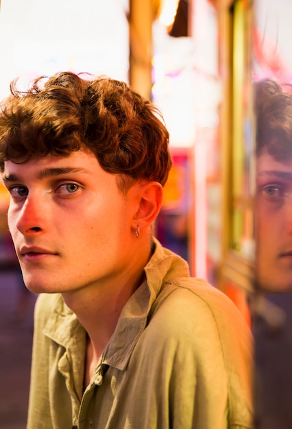 Young man looking at camera at funfair