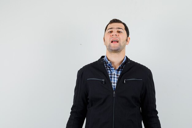 Young man looking at camera in shirt, jacket and looking confident. 