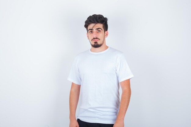 Young man looking at camera in white t-shirt and looking elegant