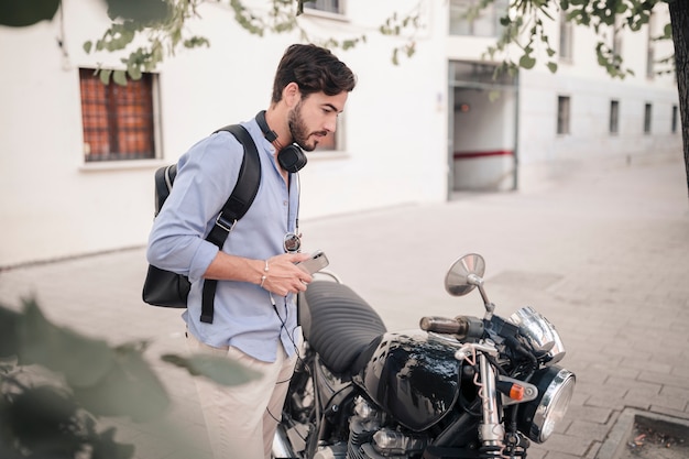 Young man looking in a motorbike mirror