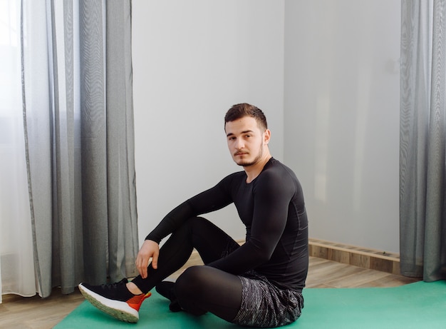 Young man making sport exercises at home