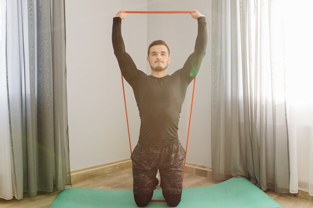 Young man making sport exercises at home