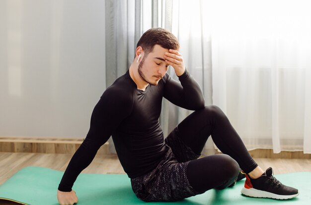 Young man making sport exercises at home