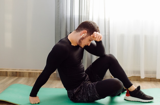 Young man making sport exercises at home