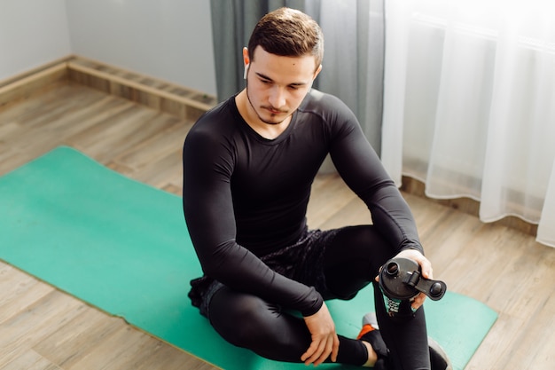 Young man making sport exercises at home