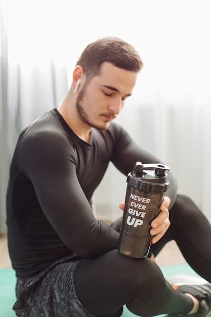 Young man making sport exercises at home