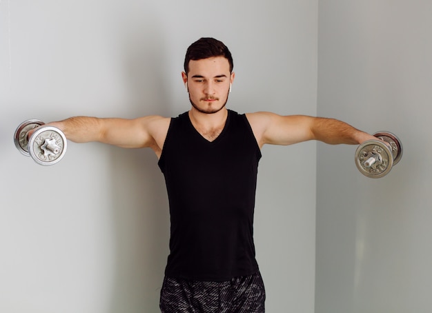 Free photo young man making sport exercises at home