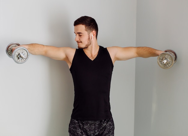 Young man making sport exercises at home