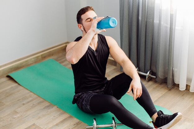 Young man making sport exercises at home