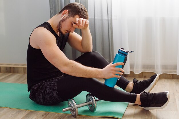 Young man making sport exercises at home