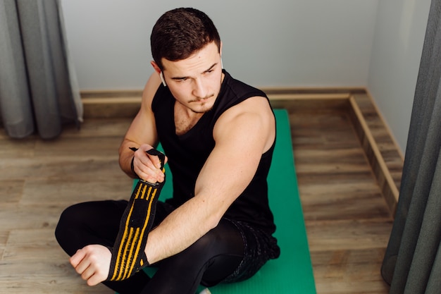 Young man making sport exercises at home