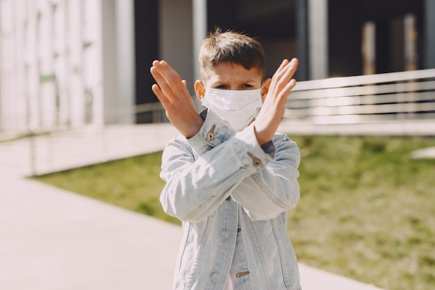 Young man in a mask standing on the street