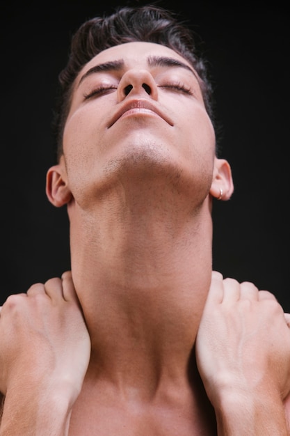 Young man massaging neck