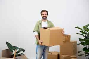 Free photo young man moving in new home