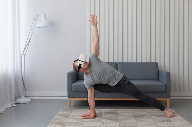 Young man playing videogames while wearing virtual reality goggles