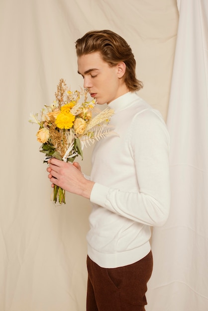 Young man portrait with flowers