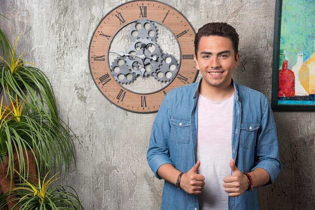 Young man posing on marble background. High quality photo